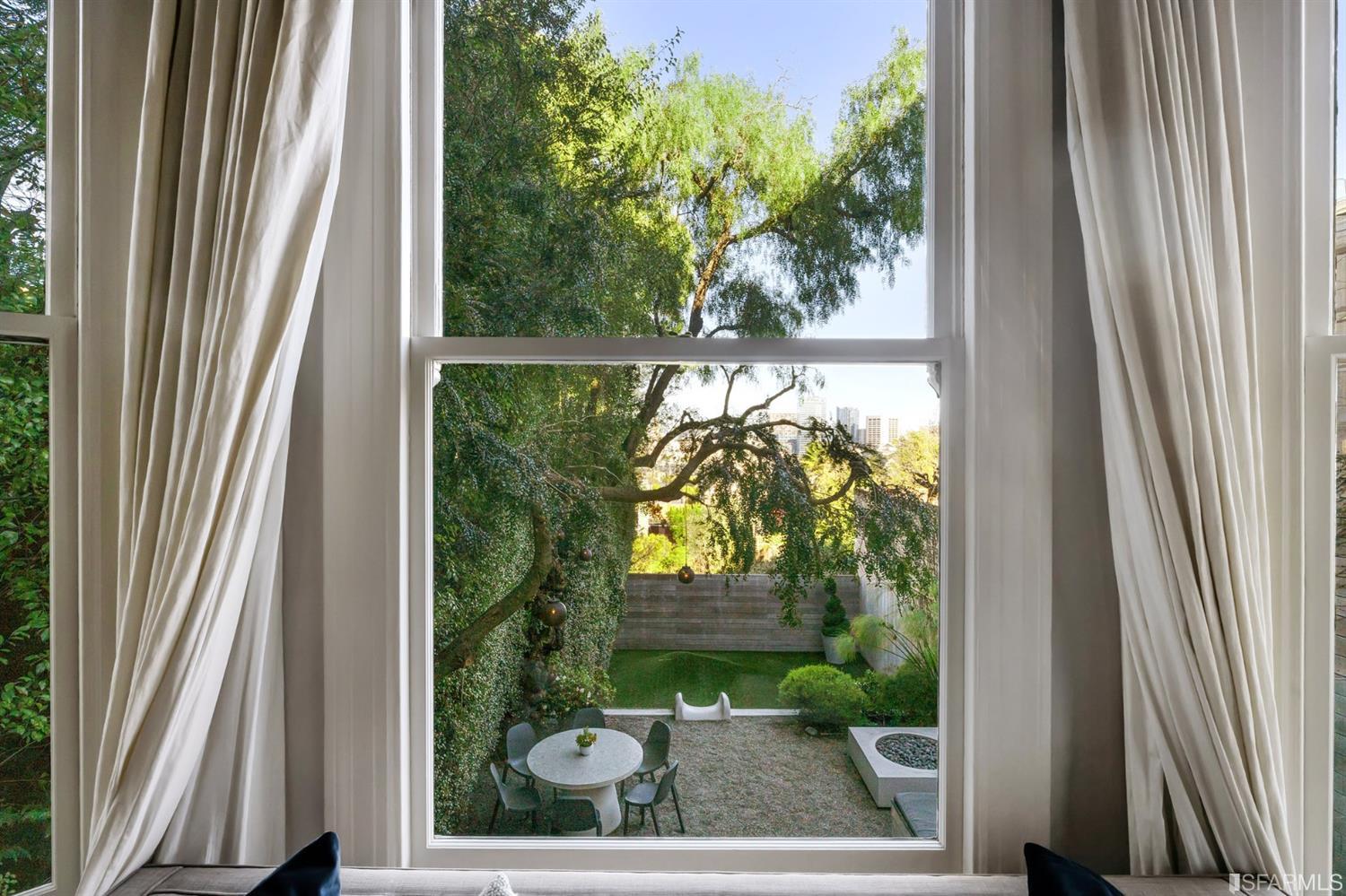 818 Steiner Street San Francisco, CA 94117 - Photo 17 of 74 Lower level is complete with a separate au pair or guest quarters that includes a bedroom/lounge and a full-bath which can be accessed separately though the home’s side entrance. Down the hall are a home gym & full-bathroom, a wine room, spacious laundry and utility areas, and a room with built-in storage that leads to the outdoor spa area with rain shower and cedar hot tub. There’s never been a better yard for entertaining; built-in seating, a roaring fire pit, and a concrete slide in its lower-level turf-lawn play space. This home offers a lifestyle surrounded by the beauty of Alamo Square Park, the vibrancy of Hayes Valley and Divisadero Corridor, and a clear connection to San Francisco’s downtown and beyond. 