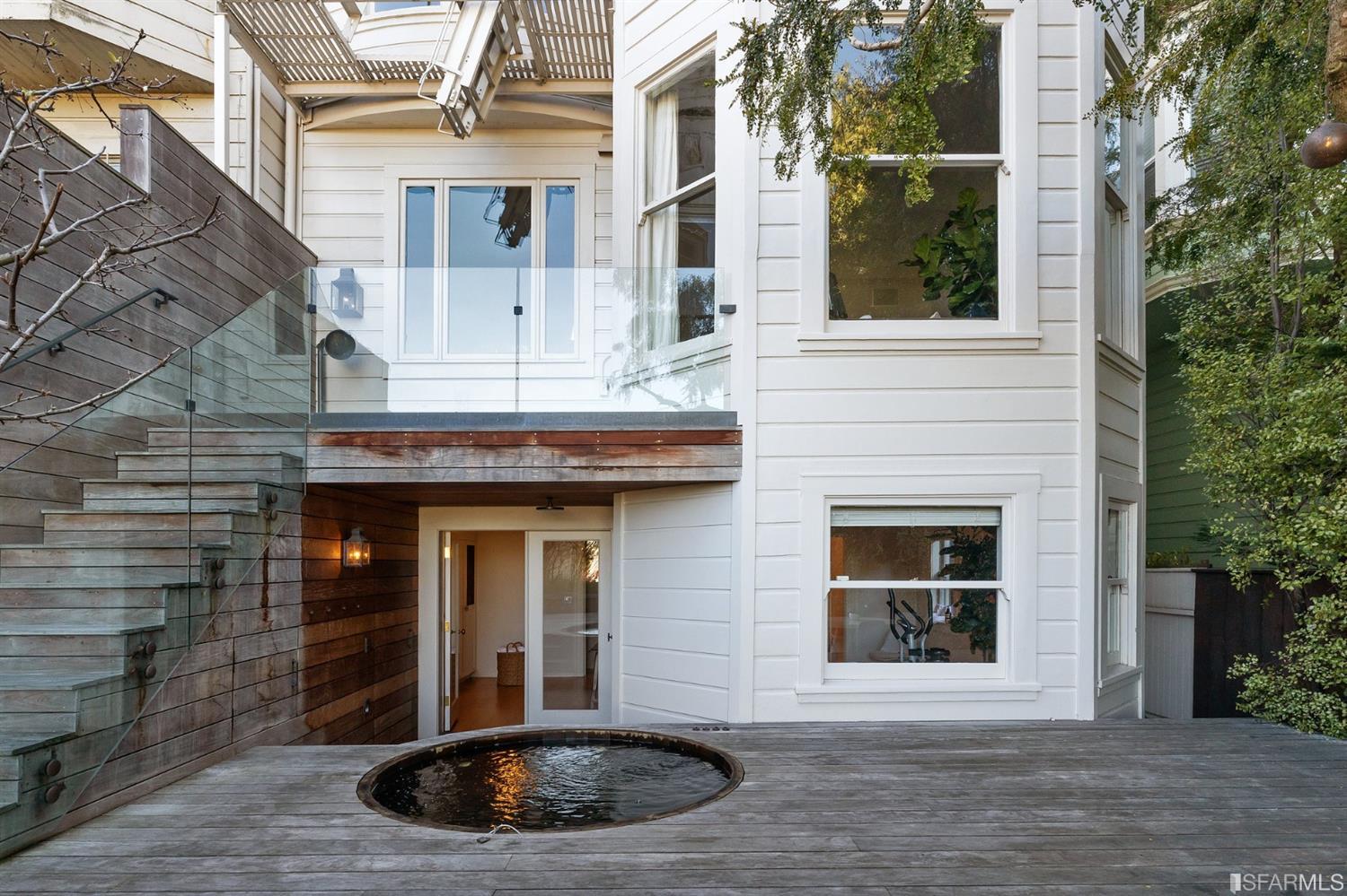 818 Steiner Street San Francisco, CA 94117 - Photo 19 of 74 Lower level is complete with a separate au pair or guest quarters that includes a bedroom/lounge and a full-bath which can be accessed separately though the home’s side entrance. Down the hall are a home gym & full-bathroom, a wine room, spacious laundry and utility areas, and a room with built-in storage that leads to the outdoor spa area with rain shower and cedar hot tub. There’s never been a better yard for entertaining; built-in seating, a roaring fire pit, and a concrete slide in its lower-level turf-lawn play space. This home offers a lifestyle surrounded by the beauty of Alamo Square Park, the vibrancy of Hayes Valley and Divisadero Corridor, and a clear connection to San Francisco’s downtown and beyond. 