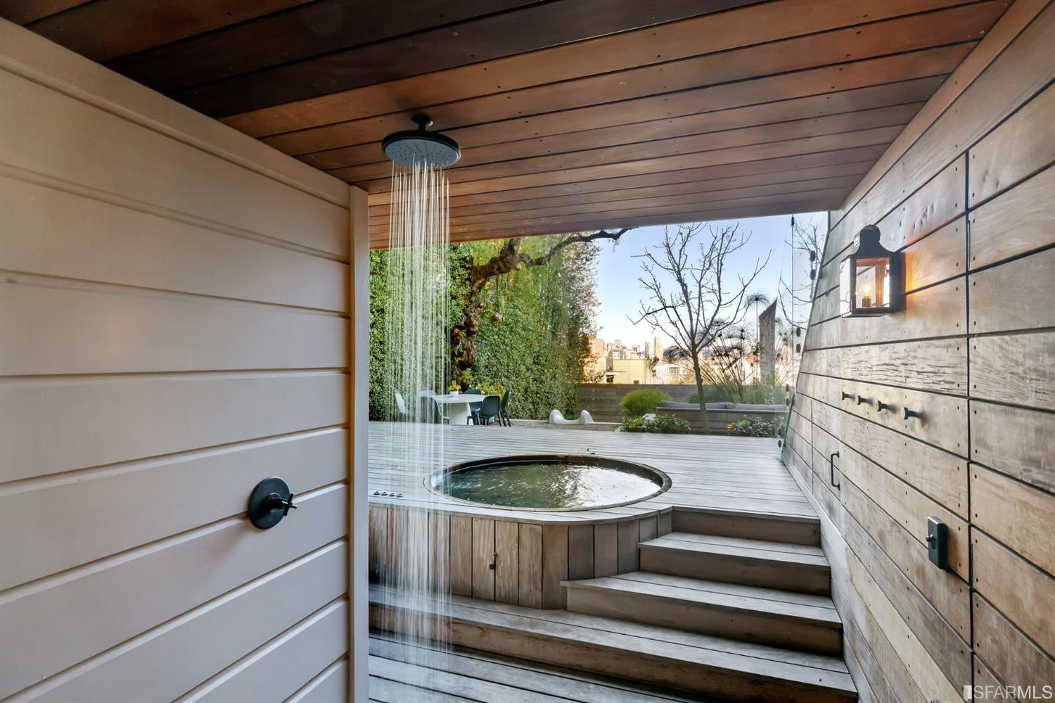 818 Steiner Street San Francisco, CA 94117 - Photo 21 of 74 Lower level is complete with a separate au pair or guest quarters that includes a bedroom/lounge and a full-bath which can be accessed separately though the home’s side entrance. Down the hall are a home gym & full-bathroom, a wine room, spacious laundry and utility areas, and a room with built-in storage that leads to the outdoor spa area with rain shower and cedar hot tub. There’s never been a better yard for entertaining; built-in seating, a roaring fire pit, and a concrete slide in its lower-level turf-lawn play space. This home offers a lifestyle surrounded by the beauty of Alamo Square Park, the vibrancy of Hayes Valley and Divisadero Corridor, and a clear connection to San Francisco’s downtown and beyond. 