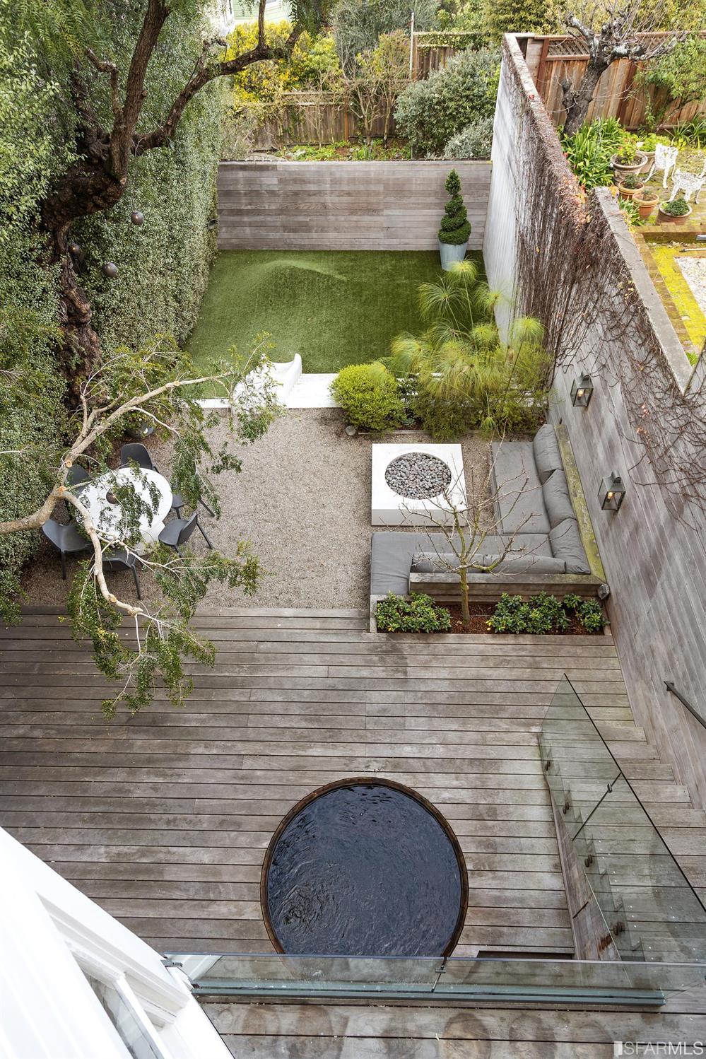 818 Steiner Street San Francisco, CA 94117 - Photo 33 of 74 Lower level is complete with a separate au pair or guest quarters that includes a bedroom/lounge and a full-bath which can be accessed separately though the home’s side entrance. Down the hall are a home gym & full-bathroom, a wine room, spacious laundry and utility areas, and a room with built-in storage that leads to the outdoor spa area with rain shower and cedar hot tub. There’s never been a better yard for entertaining; built-in seating, a roaring fire pit, and a concrete slide in its lower-level turf-lawn play space. This home offers a lifestyle surrounded by the beauty of Alamo Square Park, the vibrancy of Hayes Valley and Divisadero Corridor, and a clear connection to San Francisco’s downtown and beyond. 