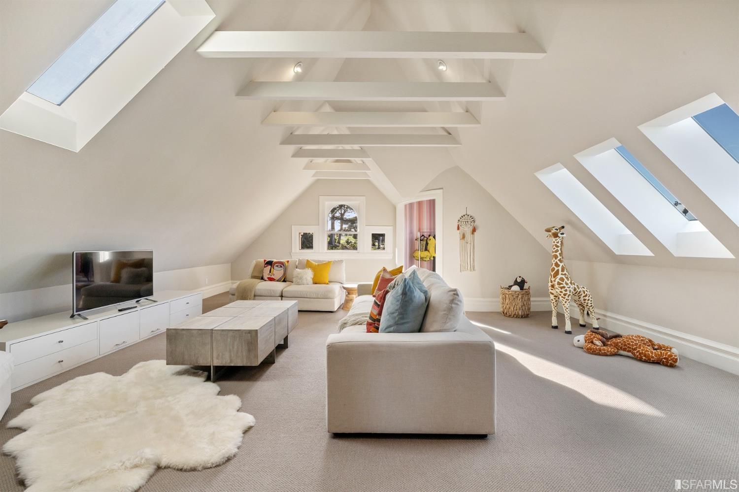 818 Steiner Street San Francisco, CA 94117 - Photo 35 of 74 Lower level is complete with a separate au pair or guest quarters that includes a bedroom/lounge and a full-bath which can be accessed separately though the home’s side entrance. Down the hall are a home gym & full-bathroom, a wine room, spacious laundry and utility areas, and a room with built-in storage that leads to the outdoor spa area with rain shower and cedar hot tub. There’s never been a better yard for entertaining; built-in seating, a roaring fire pit, and a concrete slide in its lower-level turf-lawn play space. This home offers a lifestyle surrounded by the beauty of Alamo Square Park, the vibrancy of Hayes Valley and Divisadero Corridor, and a clear connection to San Francisco’s downtown and beyond. 