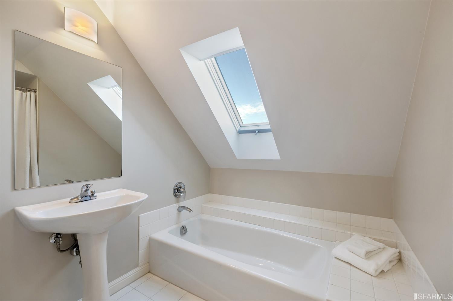 818 Steiner Street San Francisco, CA 94117 - Photo 42 of 74 Lower level is complete with a separate au pair or guest quarters that includes a bedroom/lounge and a full-bath which can be accessed separately though the home’s side entrance. Down the hall are a home gym & full-bathroom, a wine room, spacious laundry and utility areas, and a room with built-in storage that leads to the outdoor spa area with rain shower and cedar hot tub. There’s never been a better yard for entertaining; built-in seating, a roaring fire pit, and a concrete slide in its lower-level turf-lawn play space. This home offers a lifestyle surrounded by the beauty of Alamo Square Park, the vibrancy of Hayes Valley and Divisadero Corridor, and a clear connection to San Francisco’s downtown and beyond. 