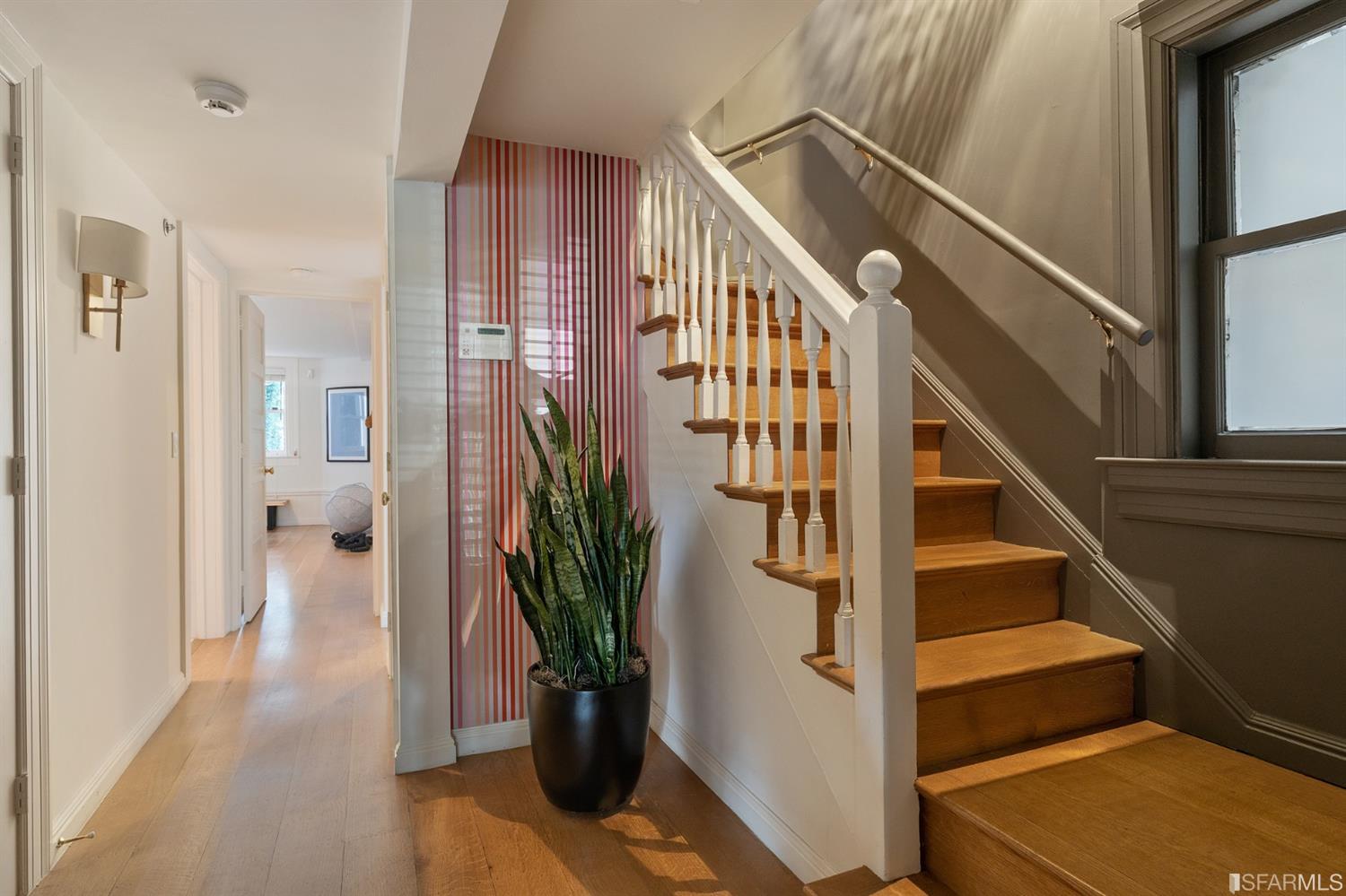 818 Steiner Street San Francisco, CA 94117 - Photo 49 of 74 Lower level is complete with a separate au pair or guest quarters that includes a bedroom/lounge and a full-bath which can be accessed separately though the home’s side entrance. Down the hall are a home gym & full-bathroom, a wine room, spacious laundry and utility areas, and a room with built-in storage that leads to the outdoor spa area with rain shower and cedar hot tub. There’s never been a better yard for entertaining; built-in seating, a roaring fire pit, and a concrete slide in its lower-level turf-lawn play space. This home offers a lifestyle surrounded by the beauty of Alamo Square Park, the vibrancy of Hayes Valley and Divisadero Corridor, and a clear connection to San Francisco’s downtown and beyond. 