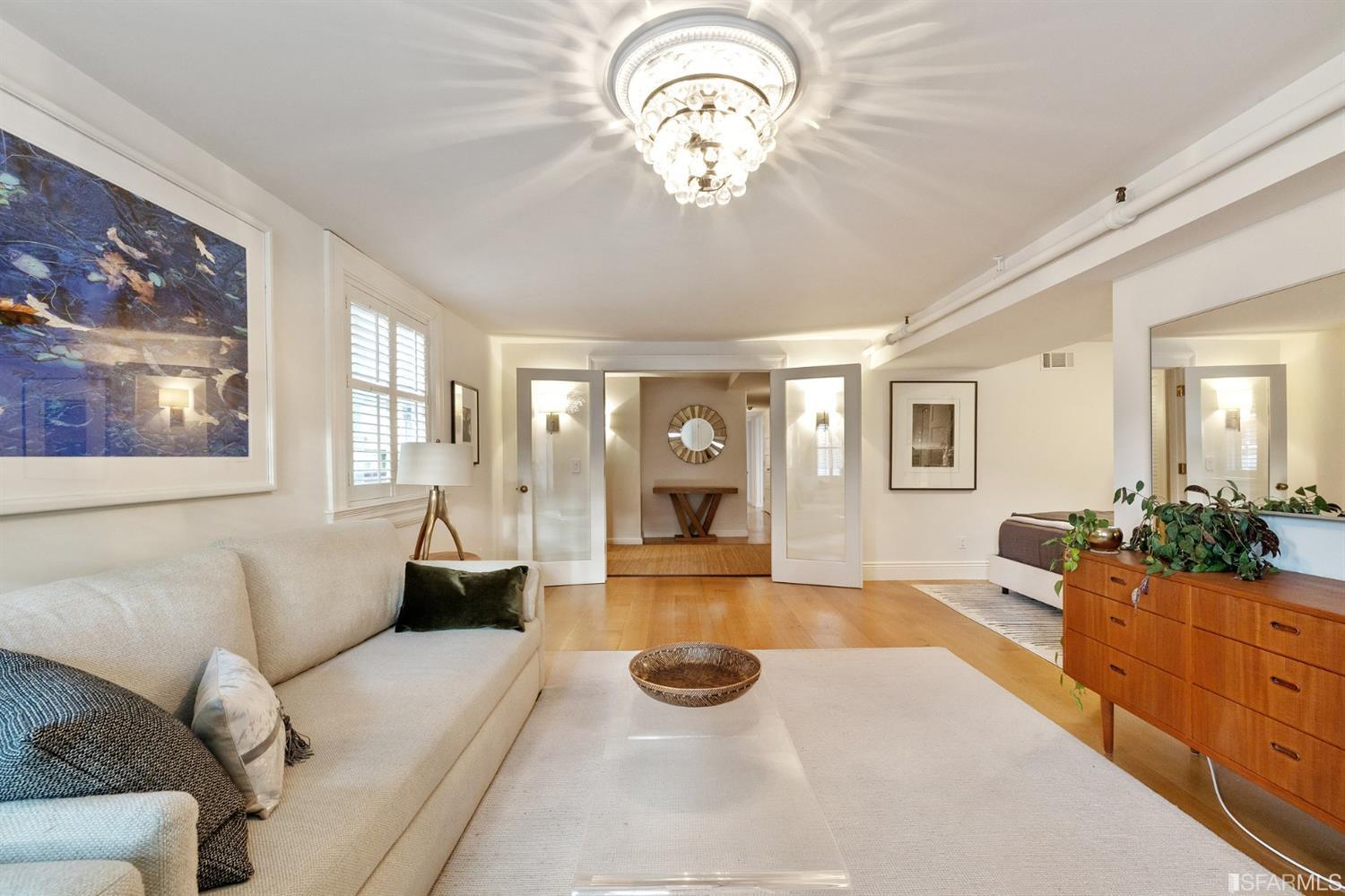 818 Steiner Street San Francisco, CA 94117 - Photo 51 of 74 Lower level is complete with a separate au pair or guest quarters that includes a bedroom/lounge and a full-bath which can be accessed separately though the home’s side entrance. Down the hall are a home gym & full-bathroom, a wine room, spacious laundry and utility areas, and a room with built-in storage that leads to the outdoor spa area with rain shower and cedar hot tub. There’s never been a better yard for entertaining; built-in seating, a roaring fire pit, and a concrete slide in its lower-level turf-lawn play space. This home offers a lifestyle surrounded by the beauty of Alamo Square Park, the vibrancy of Hayes Valley and Divisadero Corridor, and a clear connection to San Francisco’s downtown and beyond. 