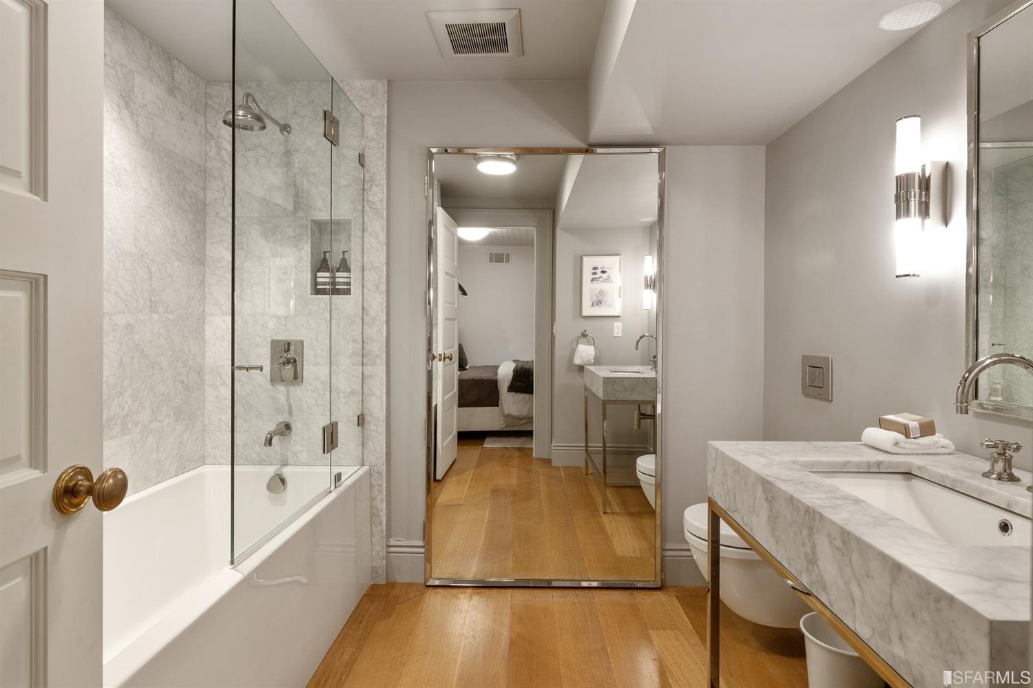 818 Steiner Street San Francisco, CA 94117 - Photo 53 of 74 Lower level is complete with a separate au pair or guest quarters that includes a bedroom/lounge and a full-bath which can be accessed separately though the home’s side entrance. Down the hall are a home gym & full-bathroom, a wine room, spacious laundry and utility areas, and a room with built-in storage that leads to the outdoor spa area with rain shower and cedar hot tub. There’s never been a better yard for entertaining; built-in seating, a roaring fire pit, and a concrete slide in its lower-level turf-lawn play space. This home offers a lifestyle surrounded by the beauty of Alamo Square Park, the vibrancy of Hayes Valley and Divisadero Corridor, and a clear connection to San Francisco’s downtown and beyond. 