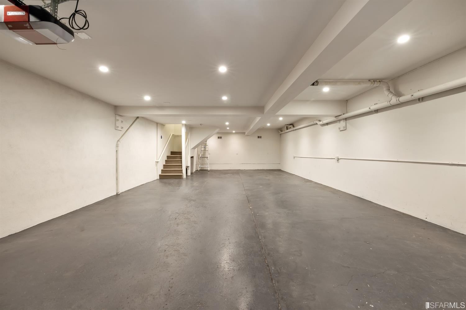 818 Steiner Street San Francisco, CA 94117 - Photo 60 of 74 Lower level is complete with a separate au pair or guest quarters that includes a bedroom/lounge and a full-bath which can be accessed separately though the home’s side entrance. Down the hall are a home gym & full-bathroom, a wine room, spacious laundry and utility areas, and a room with built-in storage that leads to the outdoor spa area with rain shower and cedar hot tub. There’s never been a better yard for entertaining; built-in seating, a roaring fire pit, and a concrete slide in its lower-level turf-lawn play space. This home offers a lifestyle surrounded by the beauty of Alamo Square Park, the vibrancy of Hayes Valley and Divisadero Corridor, and a clear connection to San Francisco’s downtown and beyond. 