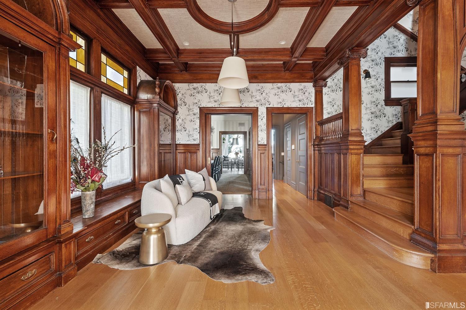 818 Steiner Street San Francisco, CA 94117 - Photo 7 of 74 Lower level is complete with a separate au pair or guest quarters that includes a bedroom/lounge and a full-bath which can be accessed separately though the home’s side entrance. Down the hall are a home gym & full-bathroom, a wine room, spacious laundry and utility areas, and a room with built-in storage that leads to the outdoor spa area with rain shower and cedar hot tub. There’s never been a better yard for entertaining; built-in seating, a roaring fire pit, and a concrete slide in its lower-level turf-lawn play space. This home offers a lifestyle surrounded by the beauty of Alamo Square Park, the vibrancy of Hayes Valley and Divisadero Corridor, and a clear connection to San Francisco’s downtown and beyond. 