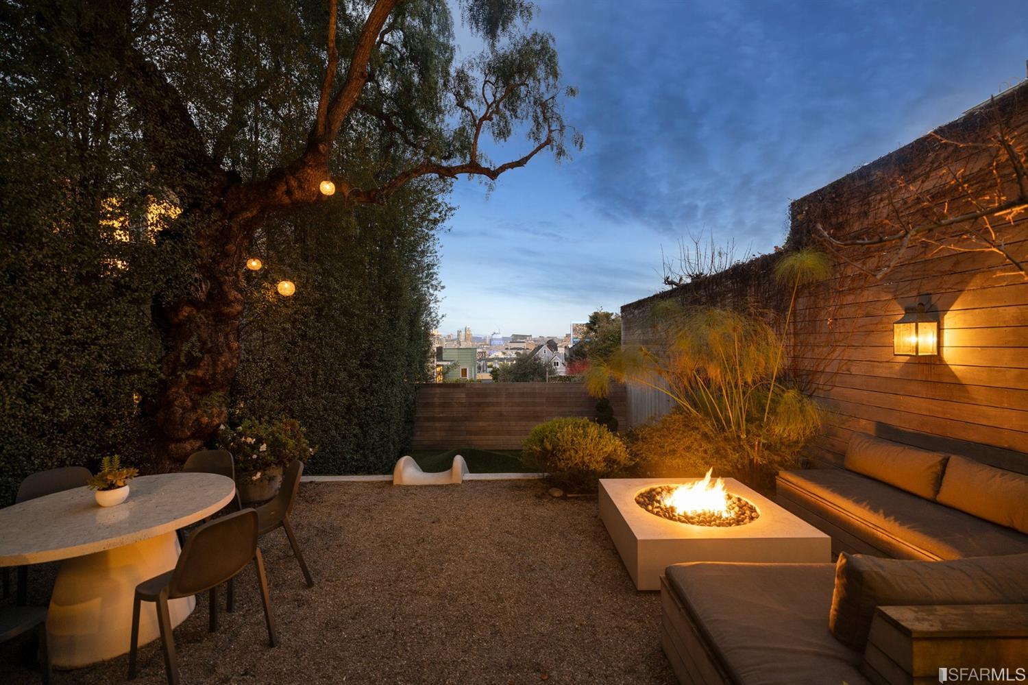 818 Steiner Street San Francisco, CA 94117 - Photo 63 of 74 Lower level is complete with a separate au pair or guest quarters that includes a bedroom/lounge and a full-bath which can be accessed separately though the home's side entrance. Down the hall are a home gym & full-bathroom, a wine room, spacious laundry and utility areas, and a room with built-in storage that leads to the outdoor spa area with rain shower and cedar hot tub. There's never been a better yard for entertaining; built-in seating, a roaring fire pit, and a concrete slide in its lower-level turf-lawn play space. This home offers a lifestyle surrounded by the beauty of Alamo Square Park, the vibrancy of Hayes Valley and Divisadero Corridor, and a clear connection to San Francisco's downtown and beyond.