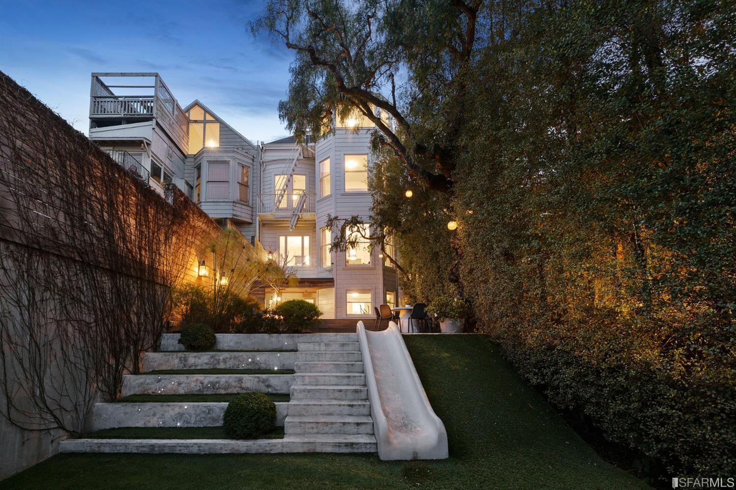 818 Steiner Street San Francisco, CA 94117 - Photo 64 of 74 Lower level is complete with a separate au pair or guest quarters that includes a bedroom/lounge and a full-bath which can be accessed separately though the home's side entrance. Down the hall are a home gym & full-bathroom, a wine room, spacious laundry and utility areas, and a room with built-in storage that leads to the outdoor spa area with rain shower and cedar hot tub. There's never been a better yard for entertaining; built-in seating, a roaring fire pit, and a concrete slide in its lower-level turf-lawn play space. This home offers a lifestyle surrounded by the beauty of Alamo Square Park, the vibrancy of Hayes Valley and Divisadero Corridor, and a clear connection to San Francisco's downtown and beyond.