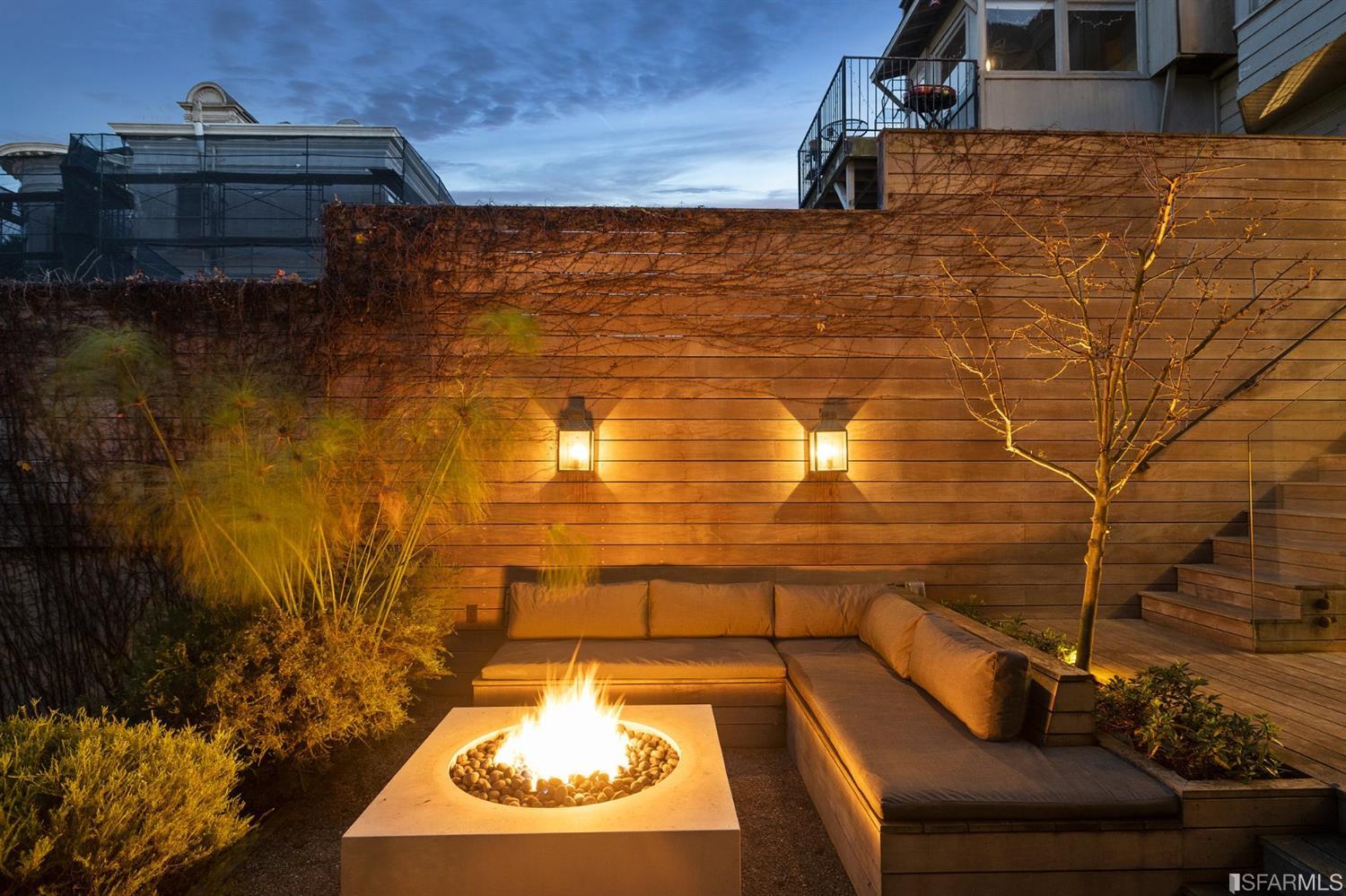 818 Steiner Street San Francisco, CA 94117 - Photo 65 of 74 Lower level is complete with a separate au pair or guest quarters that includes a bedroom/lounge and a full-bath which can be accessed separately though the home's side entrance. Down the hall are a home gym & full-bathroom, a wine room, spacious laundry and utility areas, and a room with built-in storage that leads to the outdoor spa area with rain shower and cedar hot tub. There's never been a better yard for entertaining; built-in seating, a roaring fire pit, and a concrete slide in its lower-level turf-lawn play space. This home offers a lifestyle surrounded by the beauty of Alamo Square Park, the vibrancy of Hayes Valley and Divisadero Corridor, and a clear connection to San Francisco's downtown and beyond.