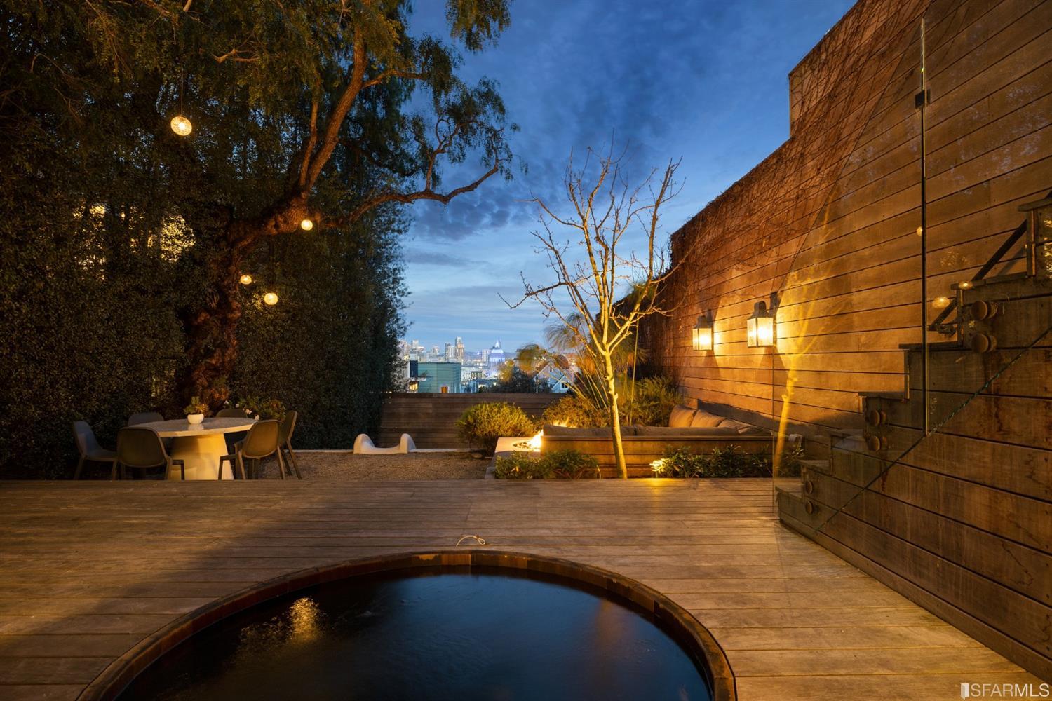 818 Steiner Street San Francisco, CA 94117 - Photo 67 of 74 Lower level is complete with a separate au pair or guest quarters that includes a bedroom/lounge and a full-bath which can be accessed separately though the home's side entrance. Down the hall are a home gym & full-bathroom, a wine room, spacious laundry and utility areas, and a room with built-in storage that leads to the outdoor spa area with rain shower and cedar hot tub. There's never been a better yard for entertaining; built-in seating, a roaring fire pit, and a concrete slide in its lower-level turf-lawn play space. This home offers a lifestyle surrounded by the beauty of Alamo Square Park, the vibrancy of Hayes Valley and Divisadero Corridor, and a clear connection to San Francisco's downtown and beyond.