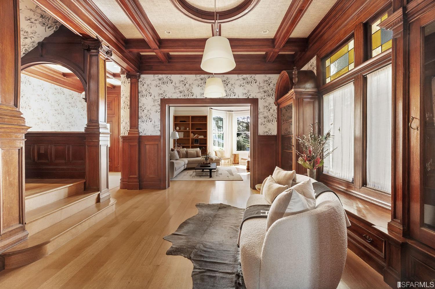 818 Steiner Street San Francisco, CA 94117 - Photo 8 of 74 Lower level is complete with a separate au pair or guest quarters that includes a bedroom/lounge and a full-bath which can be accessed separately though the home’s side entrance. Down the hall are a home gym & full-bathroom, a wine room, spacious laundry and utility areas, and a room with built-in storage that leads to the outdoor spa area with rain shower and cedar hot tub. There’s never been a better yard for entertaining; built-in seating, a roaring fire pit, and a concrete slide in its lower-level turf-lawn play space. This home offers a lifestyle surrounded by the beauty of Alamo Square Park, the vibrancy of Hayes Valley and Divisadero Corridor, and a clear connection to San Francisco’s downtown and beyond. 