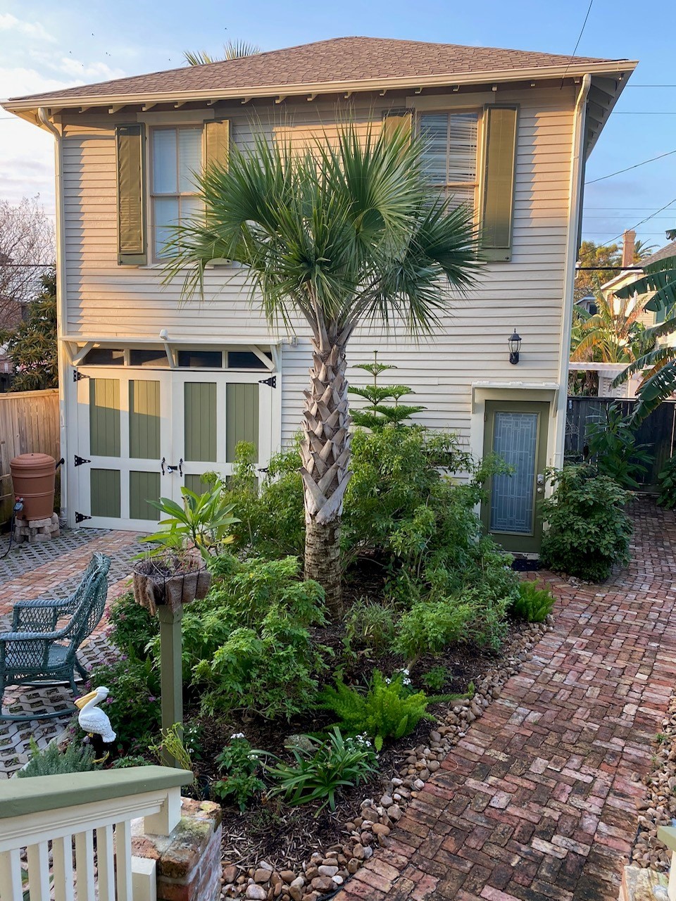 a front view of a house with a yard and potted plants