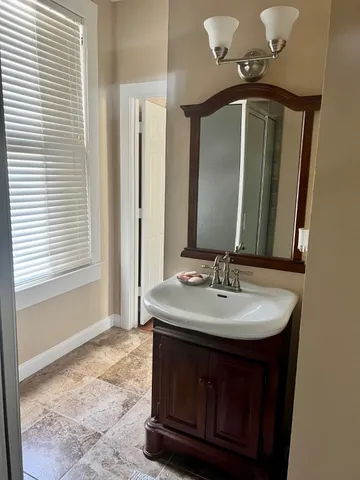 a bathroom with a sink and a mirror