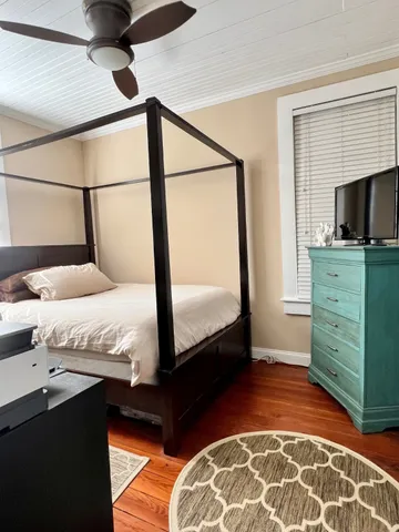 a bedroom with a bed and a television