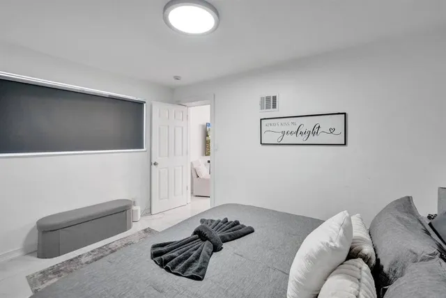 a bedroom with a bed and a couch