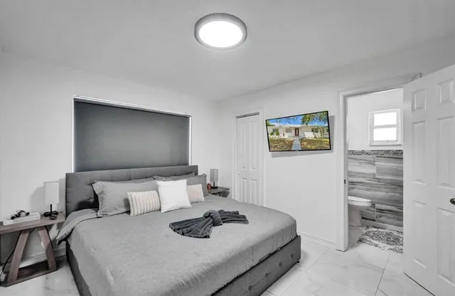 a bedroom with a bed and a lamp