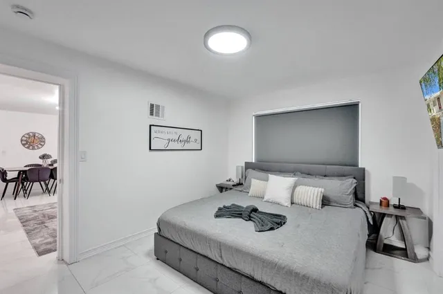 a bedroom with a bed and a table