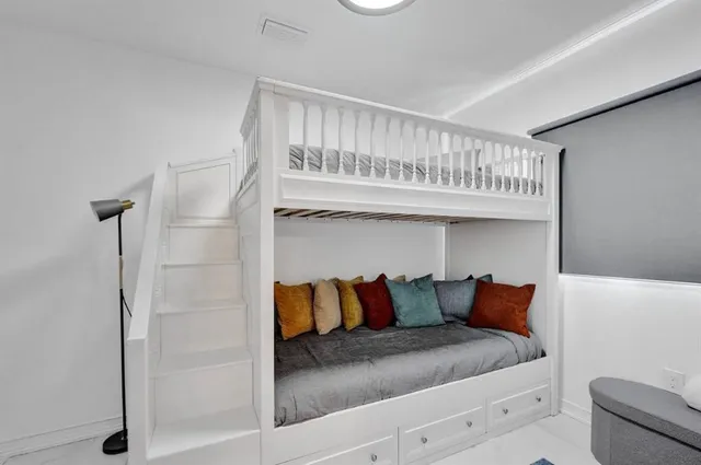 a view of bedroom with furniture and book shelf