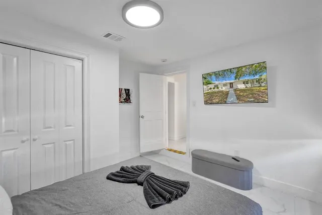 a bedroom with a bed and a couch