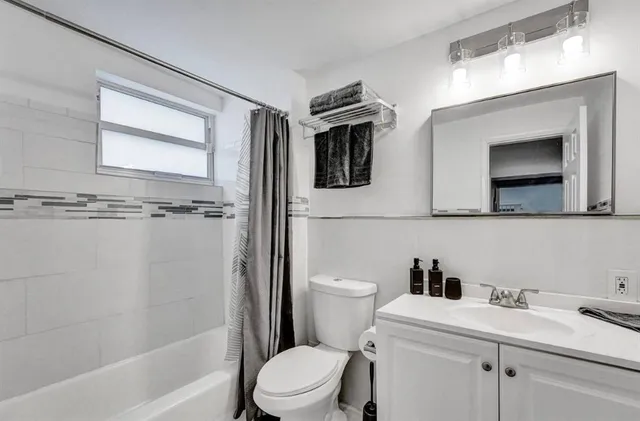 a bathroom with a toilet a sink and a bathtub