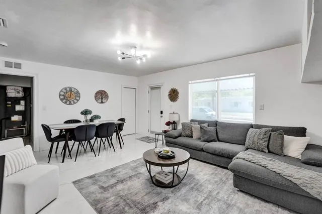 a living room with furniture and a large window
