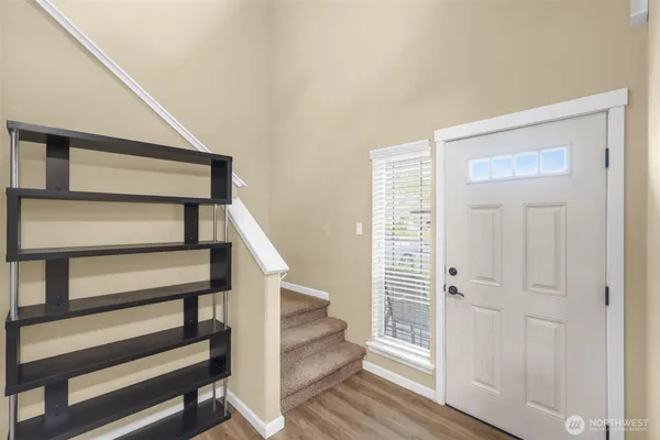 a view of entryway with wooden floor and stairs