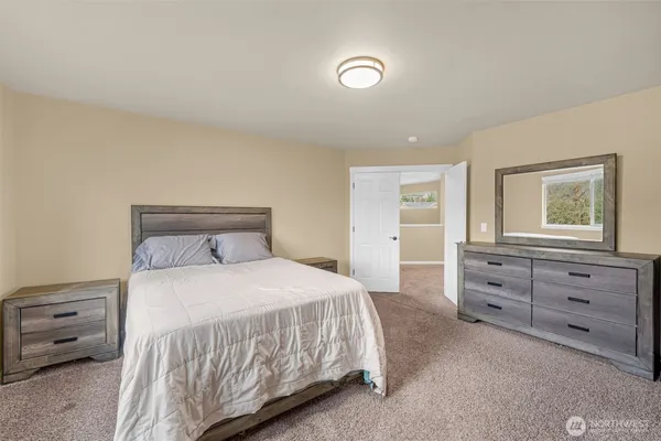 a bedroom with a bed and a dresser