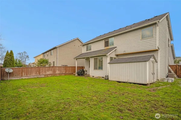 a view of a house with a yard and garage