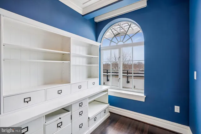 a view of cabinets with wooden floor and window