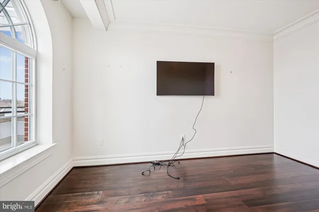 a room with a floor and a flat screen tv