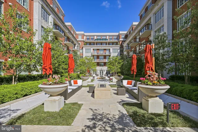 a view of a patio with a table and chairs and potted plants