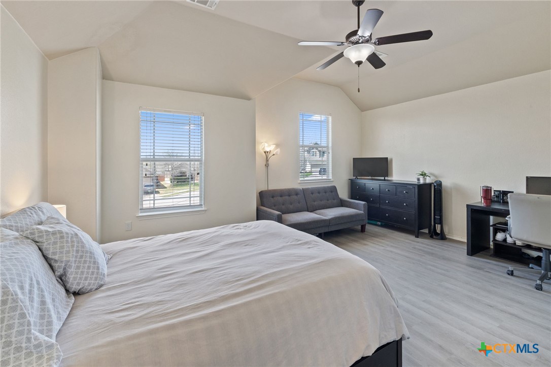 10113 Copper Ridge Cove Austin, TX 78747 - Photo 17 of 32 a bedroom with furniture and a window
