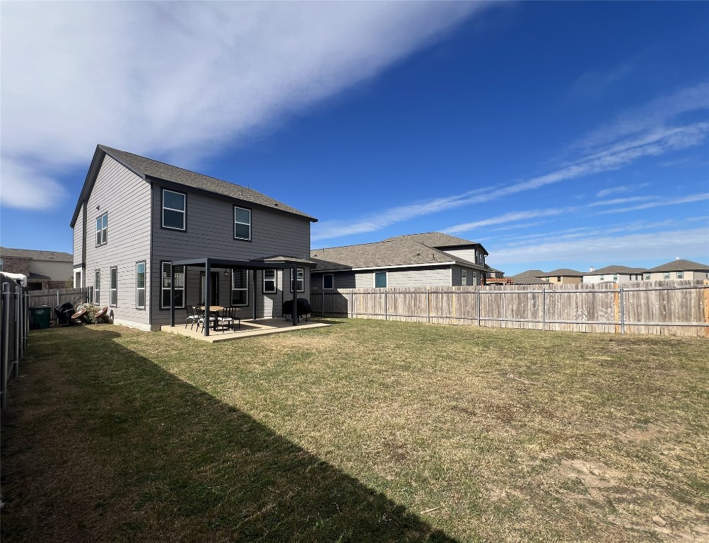 14313 James Buchanan Street Manor, TX 78653 - Photo 17 of 19 a view of a house with a yard