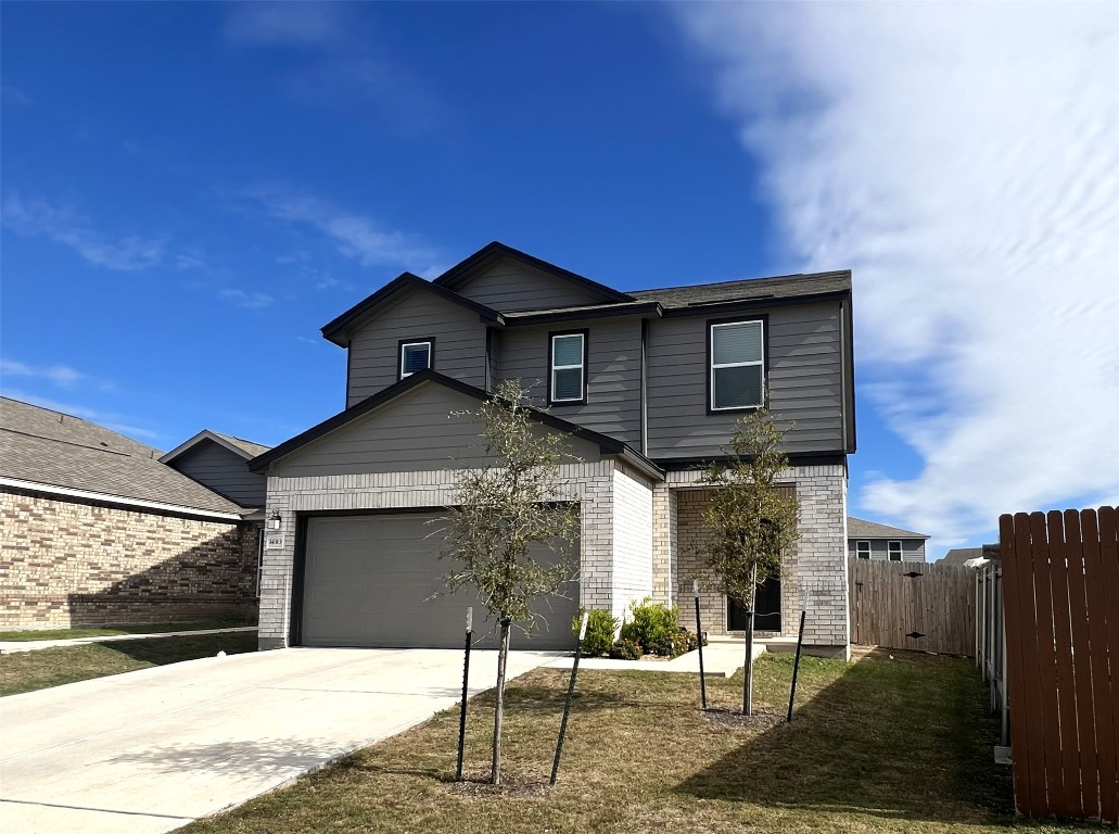 14313 James Buchanan Street Manor, TX 78653 - Photo 2 of 19 a front view of a house with garden