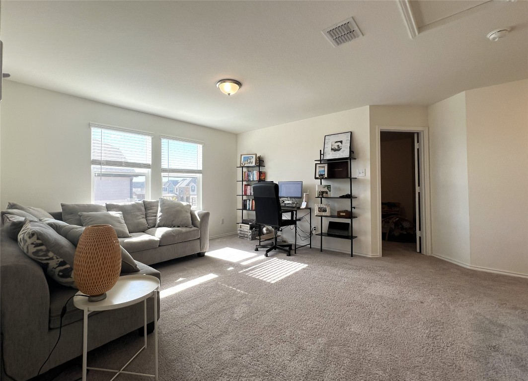 14313 James Buchanan Street Manor, TX 78653 - Photo 10 of 19 a living room with furniture and a flat screen tv