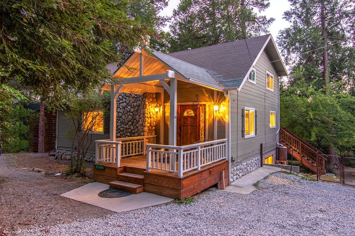 25341 Tahquitz Road Idyllwild, CA 92549 - Photo 1 of 56 a view of a house with a yard and wooden deck