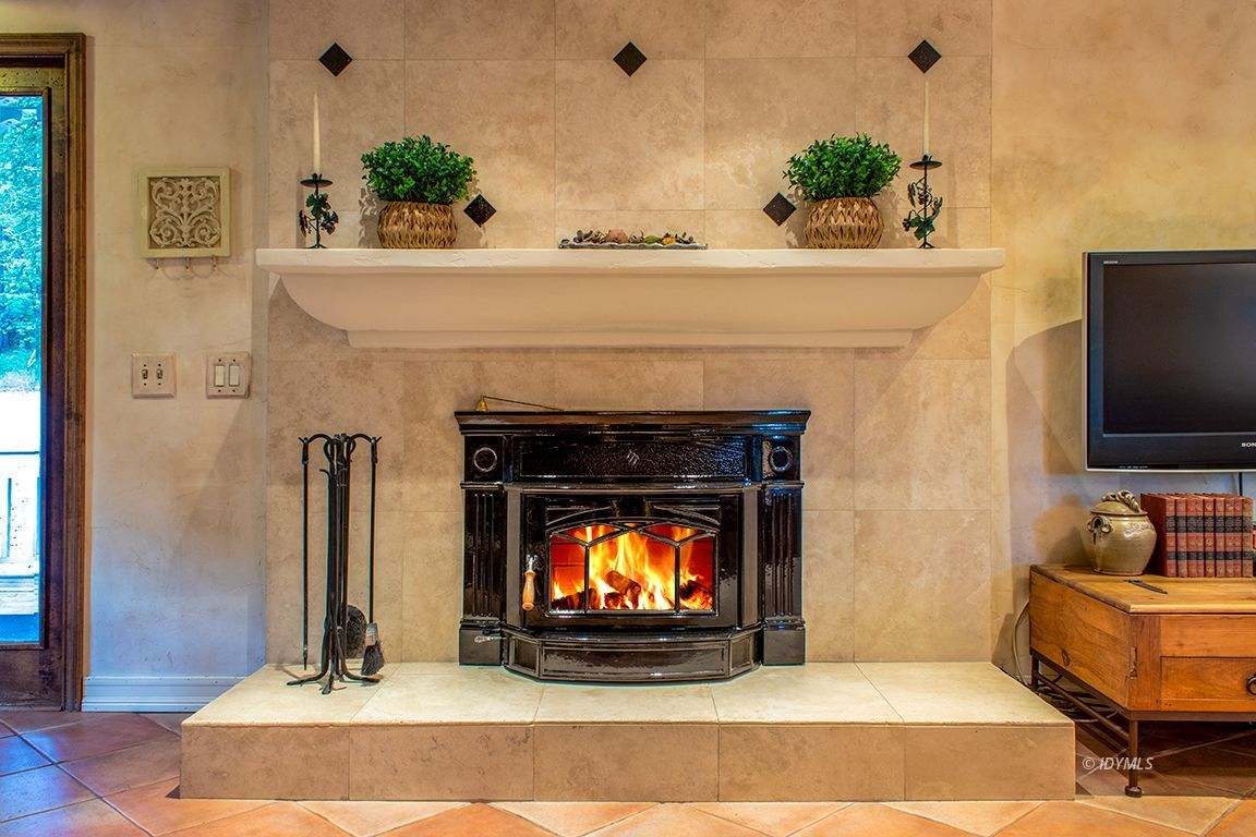 25341 Tahquitz Road Idyllwild, CA 92549 - Photo 11 of 56 a living room with furniture and a fireplace