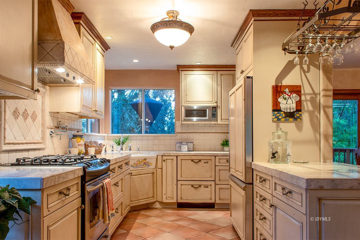 25341 Tahquitz Road Idyllwild, CA 92549 - Photo 17 of 56 a kitchen with a sink stove and cabinets