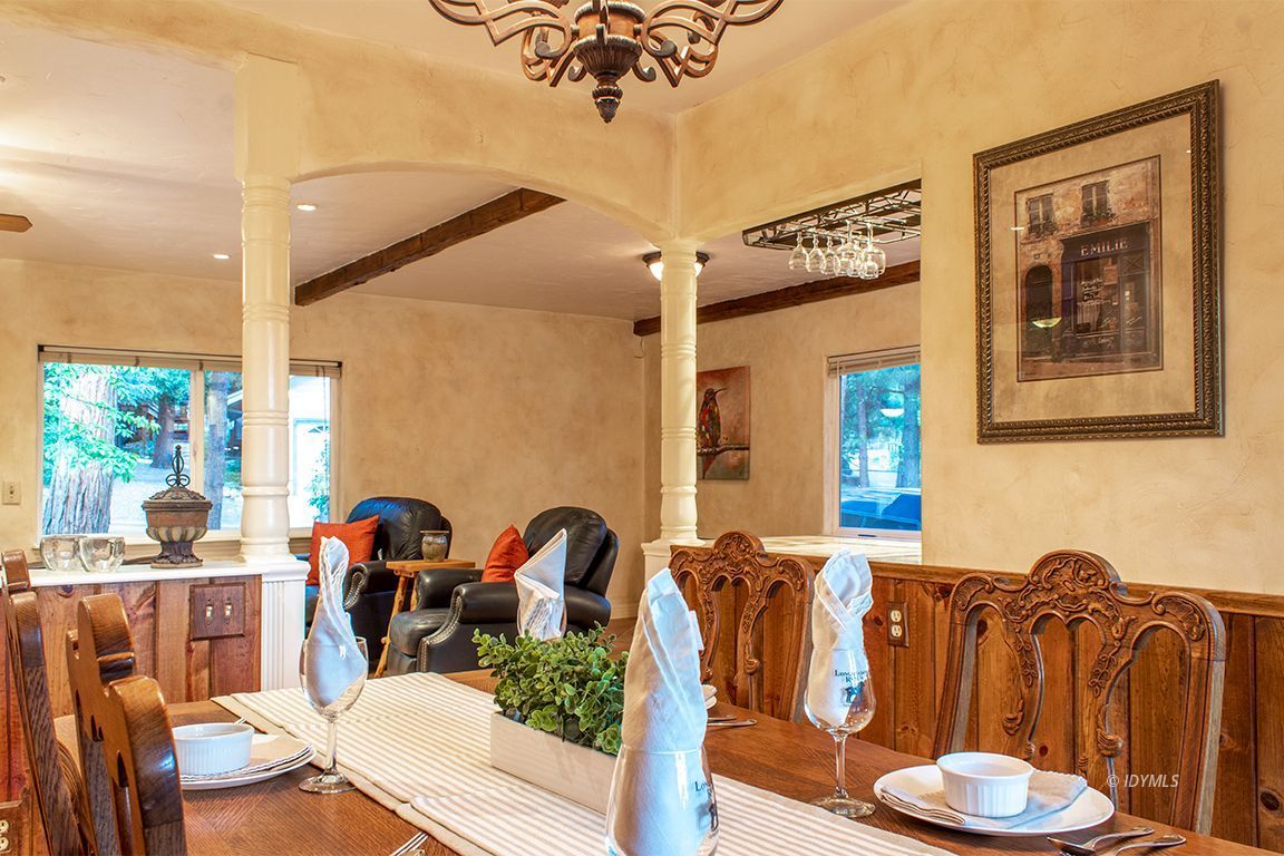 25341 Tahquitz Road Idyllwild, CA 92549 - Photo 25 of 56 a view of a dining room with furniture a chandelier and wooden floor