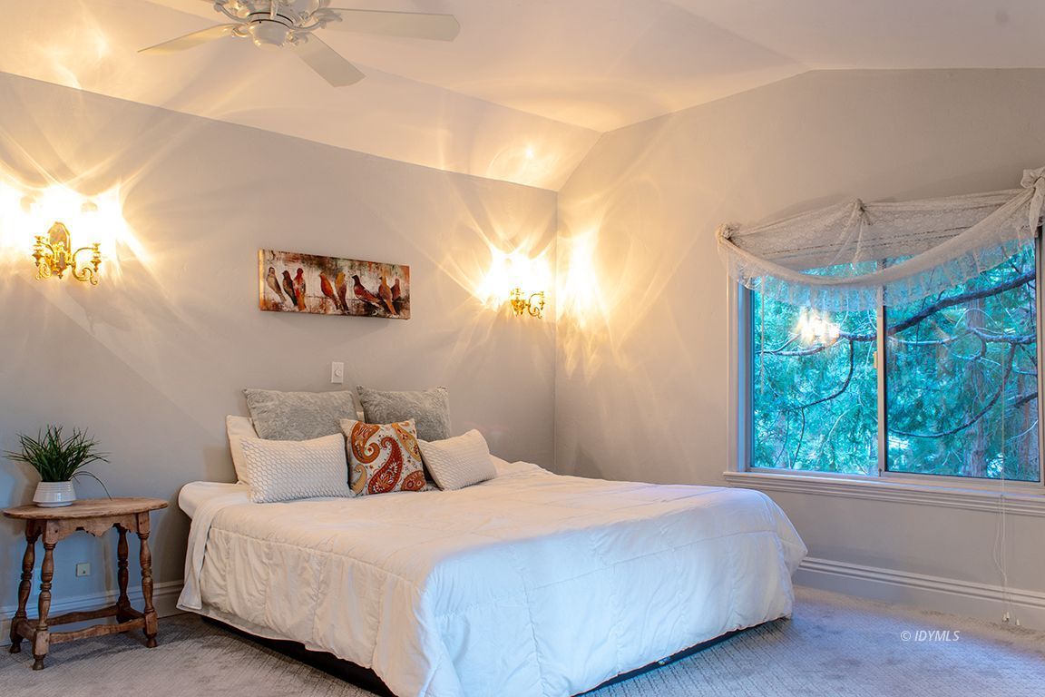25341 Tahquitz Road Idyllwild, CA 92549 - Photo 33 of 56 a bedroom with a bed and a chandelier