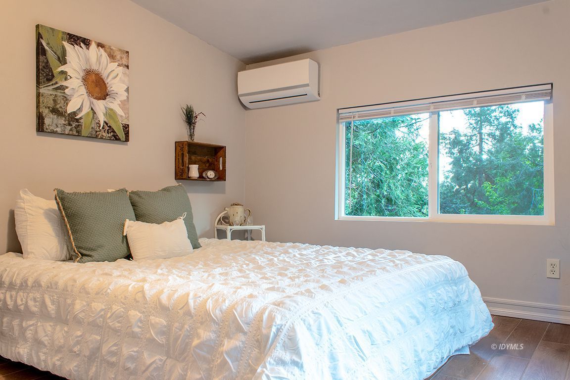25341 Tahquitz Road Idyllwild, CA 92549 - Photo 35 of 56 a bedroom with a bed and a large window