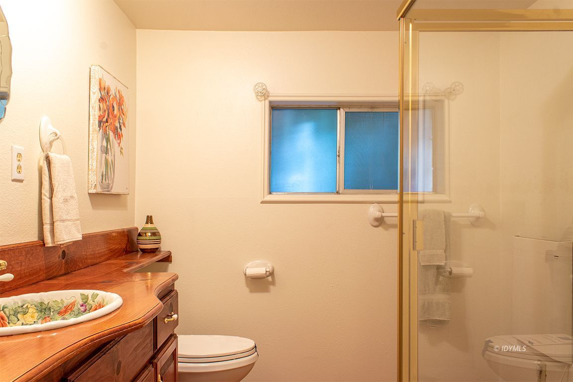 25341 Tahquitz Road Idyllwild, CA 92549 - Photo 47 of 56 a bathroom with a granite countertop toilet sink and mirror