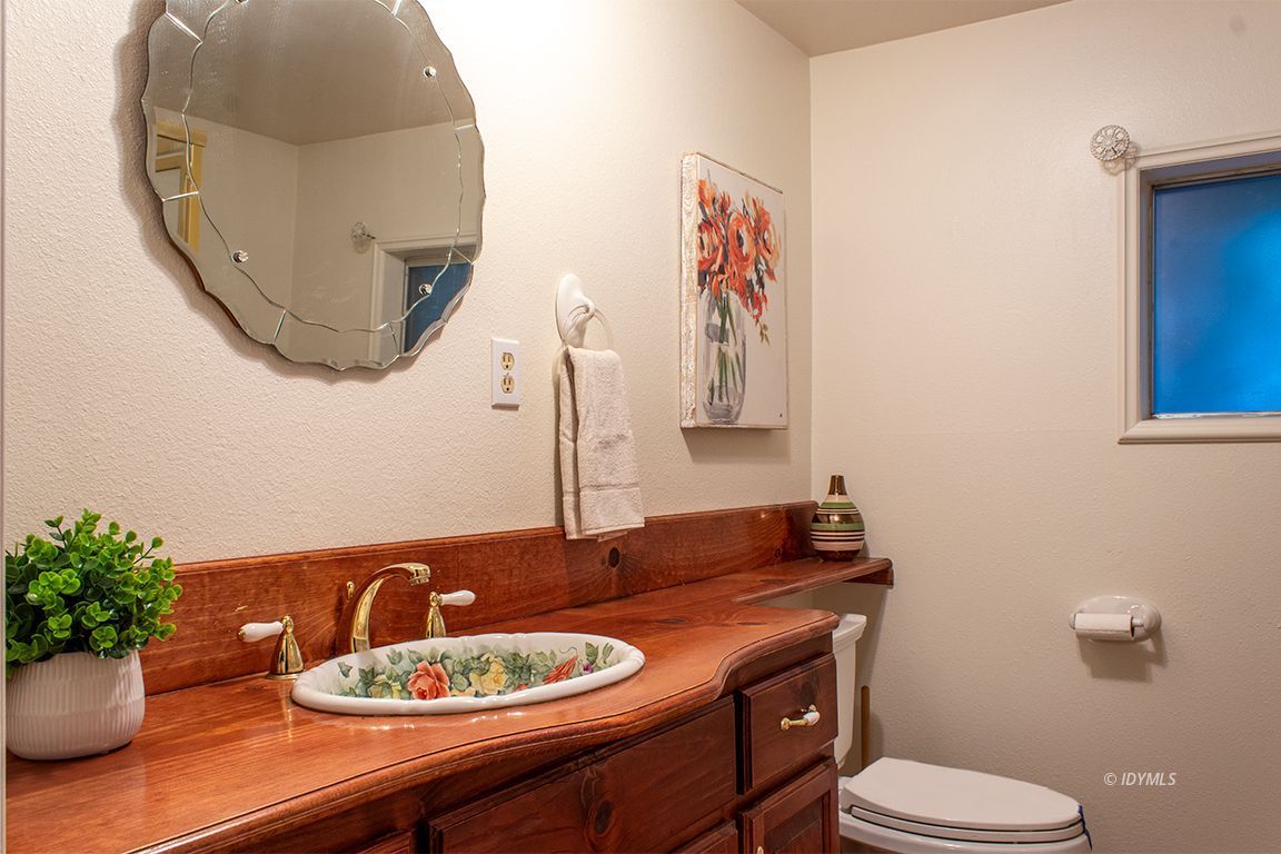 25341 Tahquitz Road Idyllwild, CA 92549 - Photo 48 of 56 a bathroom with a toilet a sink and a mirror