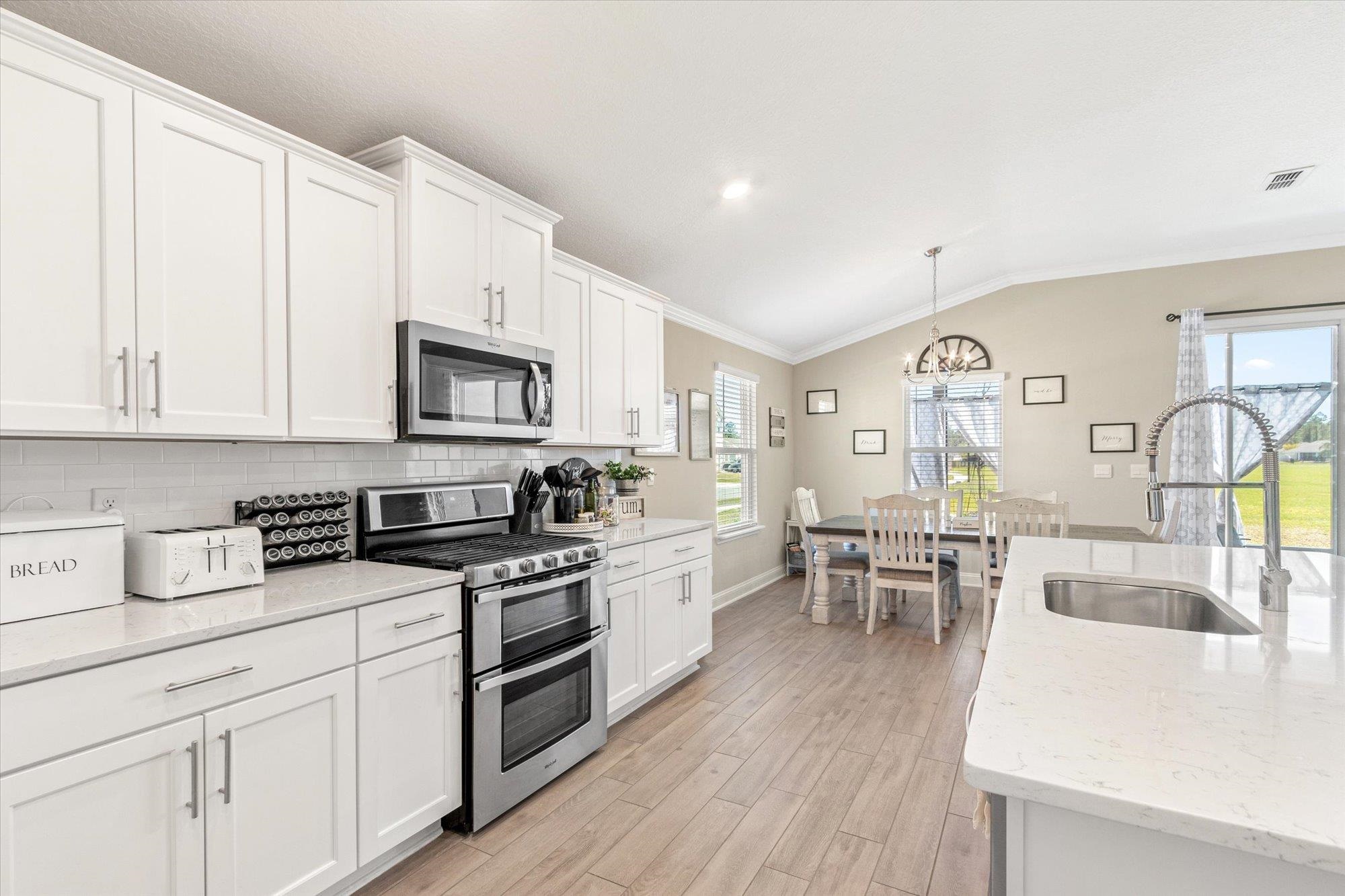 23 Alagon Way Street St. Augustine, FL 32084 - Photo 11 of 51 a kitchen with white cabinets and appliances
