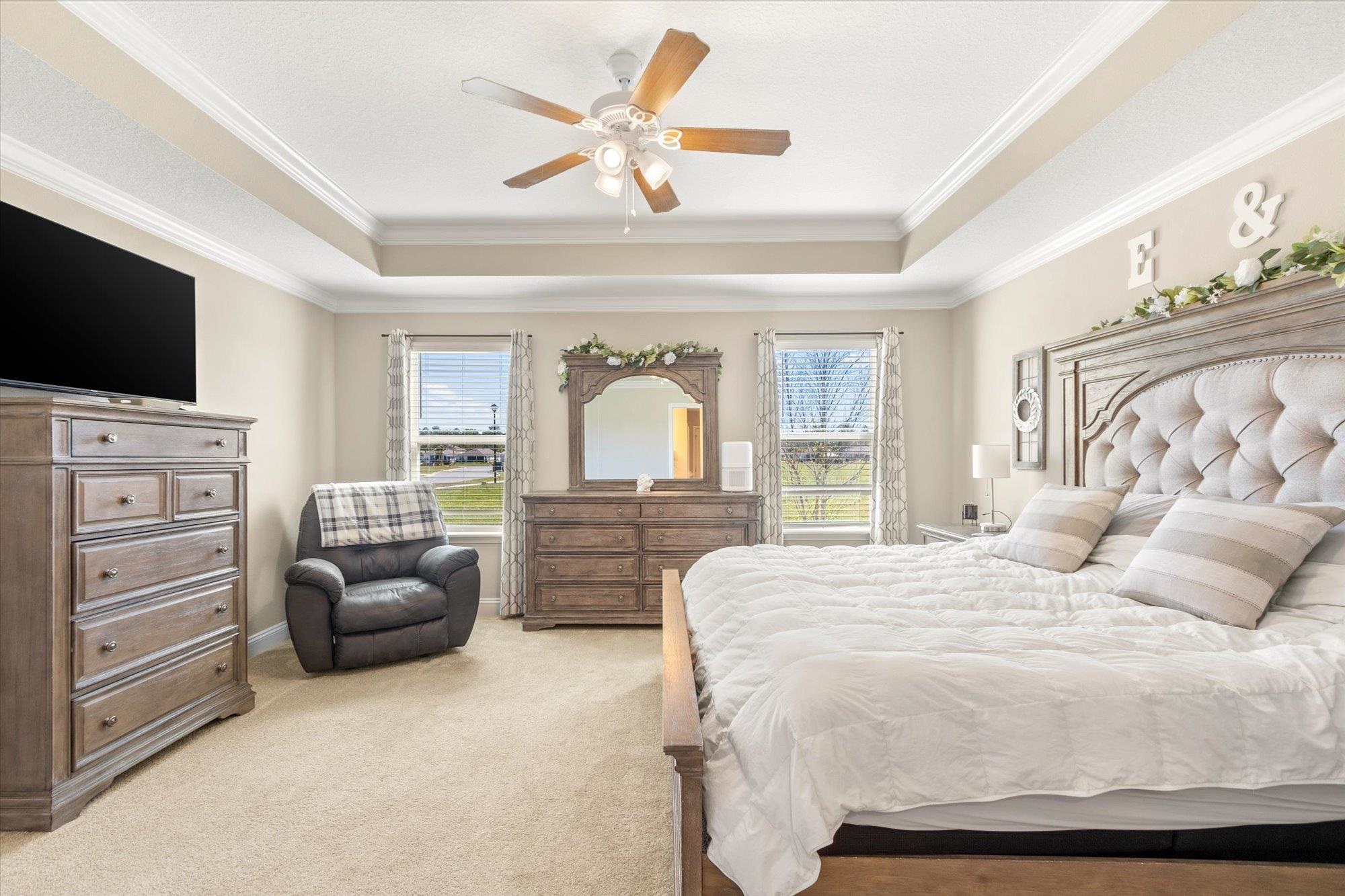 23 Alagon Way Street St. Augustine, FL 32084 - Photo 14 of 51 a bedroom with a bed a couch and a flat screen tv