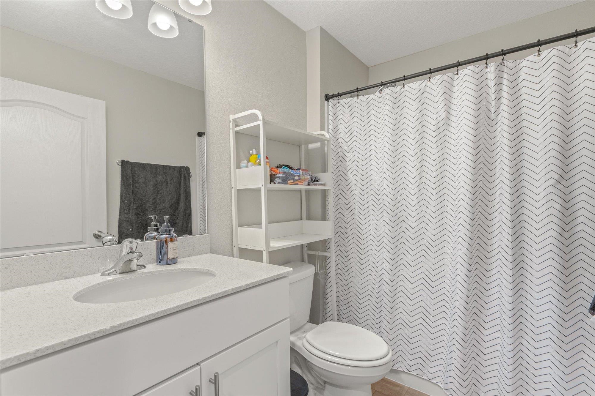 23 Alagon Way Street St. Augustine, FL 32084 - Photo 20 of 51 a bathroom with a sink a toilet and shower curtain