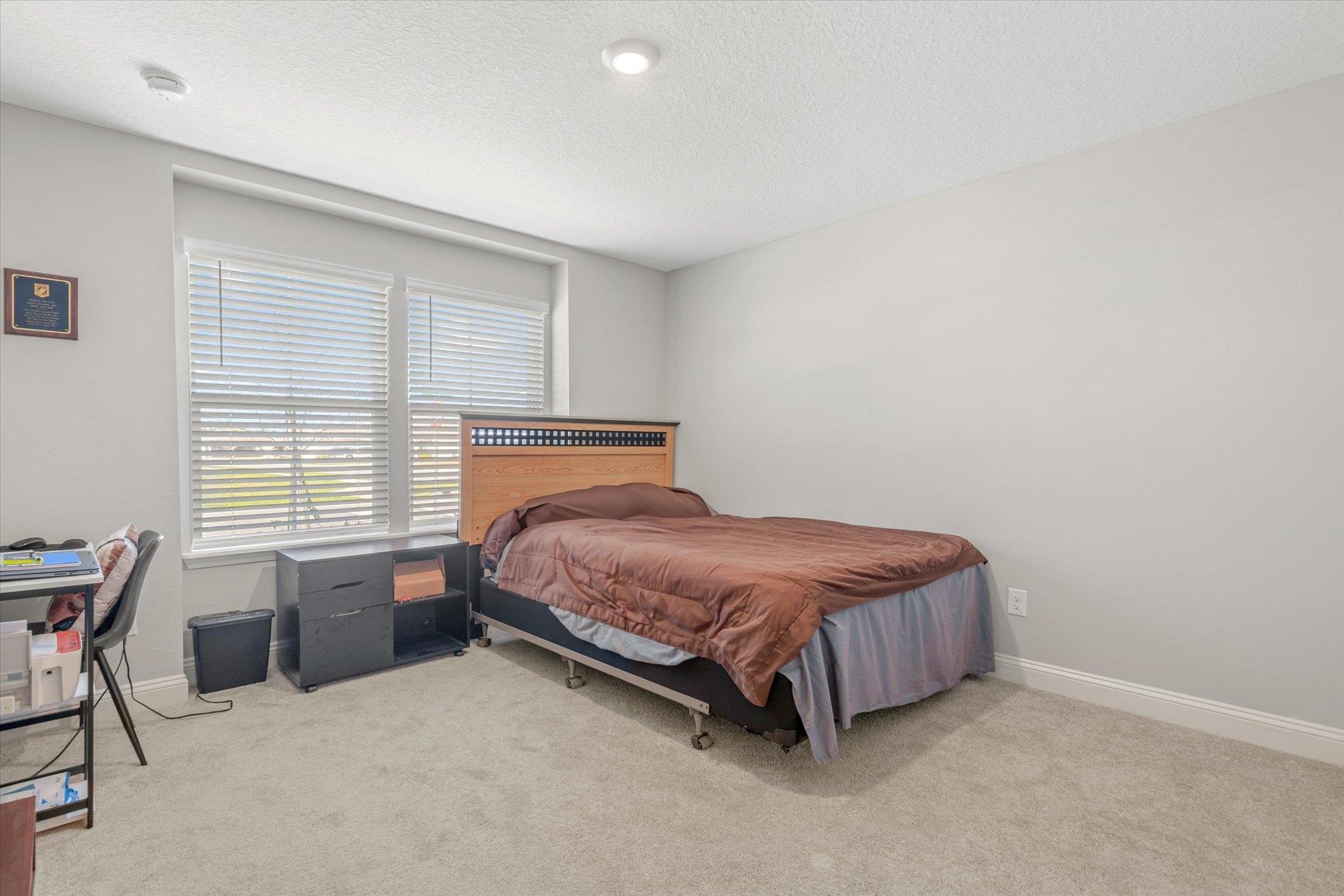 23 Alagon Way Street St. Augustine, FL 32084 - Photo 22 of 51 a spacious bedroom with a bed and a window