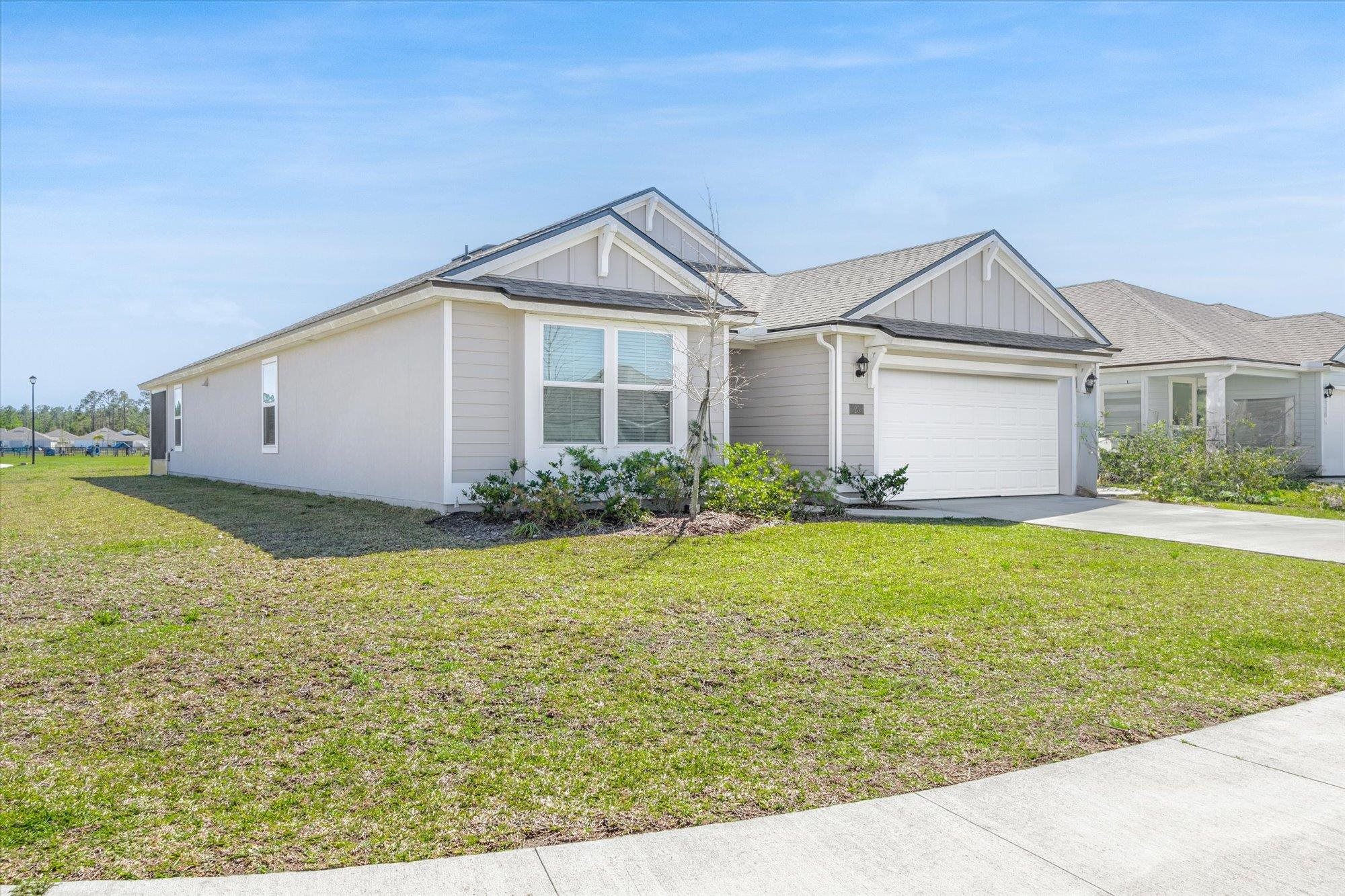 23 Alagon Way Street St. Augustine, FL 32084 - Photo 30 of 51 a view of a white house next to a yard with potted plants