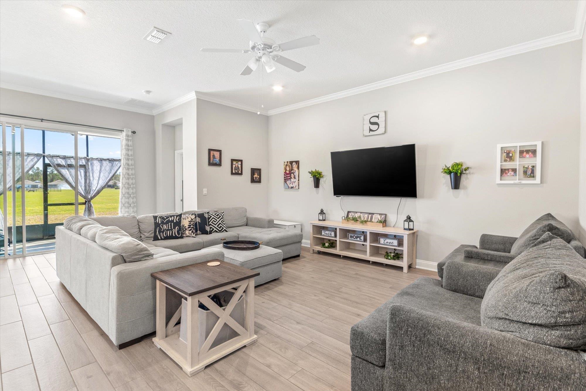 23 Alagon Way Street St. Augustine, FL 32084 - Photo 7 of 51 a living room with furniture and a flat screen tv